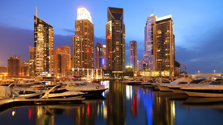Dubai Marina which includes central business district, a marina and boating