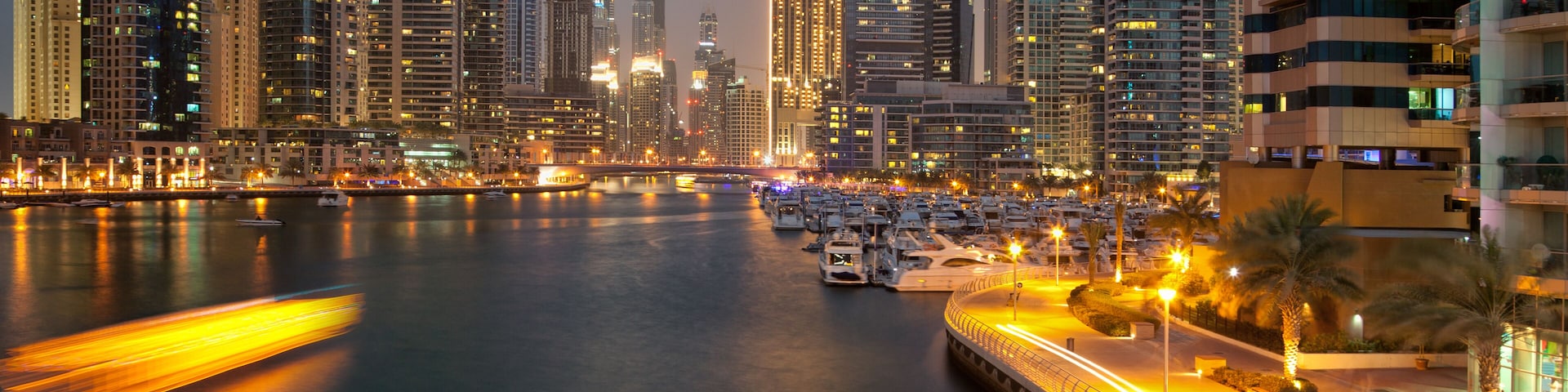 Skyscrapers of Dubai Marina captured in the dusk. Dubai Marina is an artificial canal city, carved along a two mile stretch of Persian Gulf shoreline.