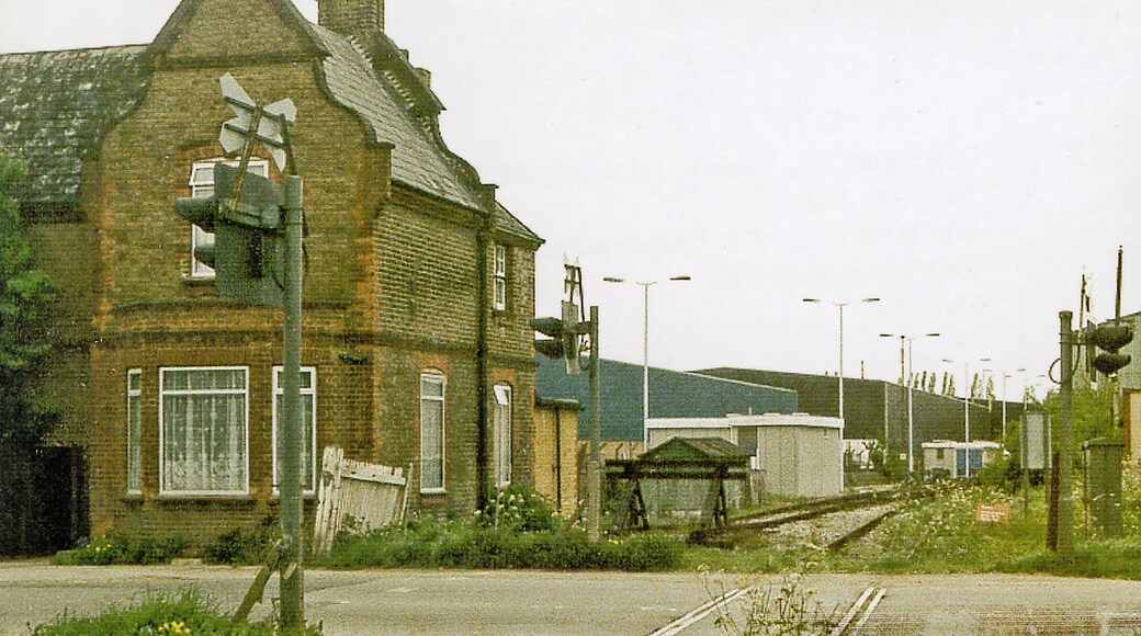 Site of Colnbrook station, 1986, View northward across the B3378 (original Bath Road), towards West Drayton: ex-GWR West Drayton - Staines branch. The station was closed when the passenger service on the branch ceased from 29/3/65. Goods traffic ceased from 3/1/66, but as the photograph shows the line remains open to this point from West Drayton, for traffic to a fuel depot for Heathrow Airport and to an aggregates depot.