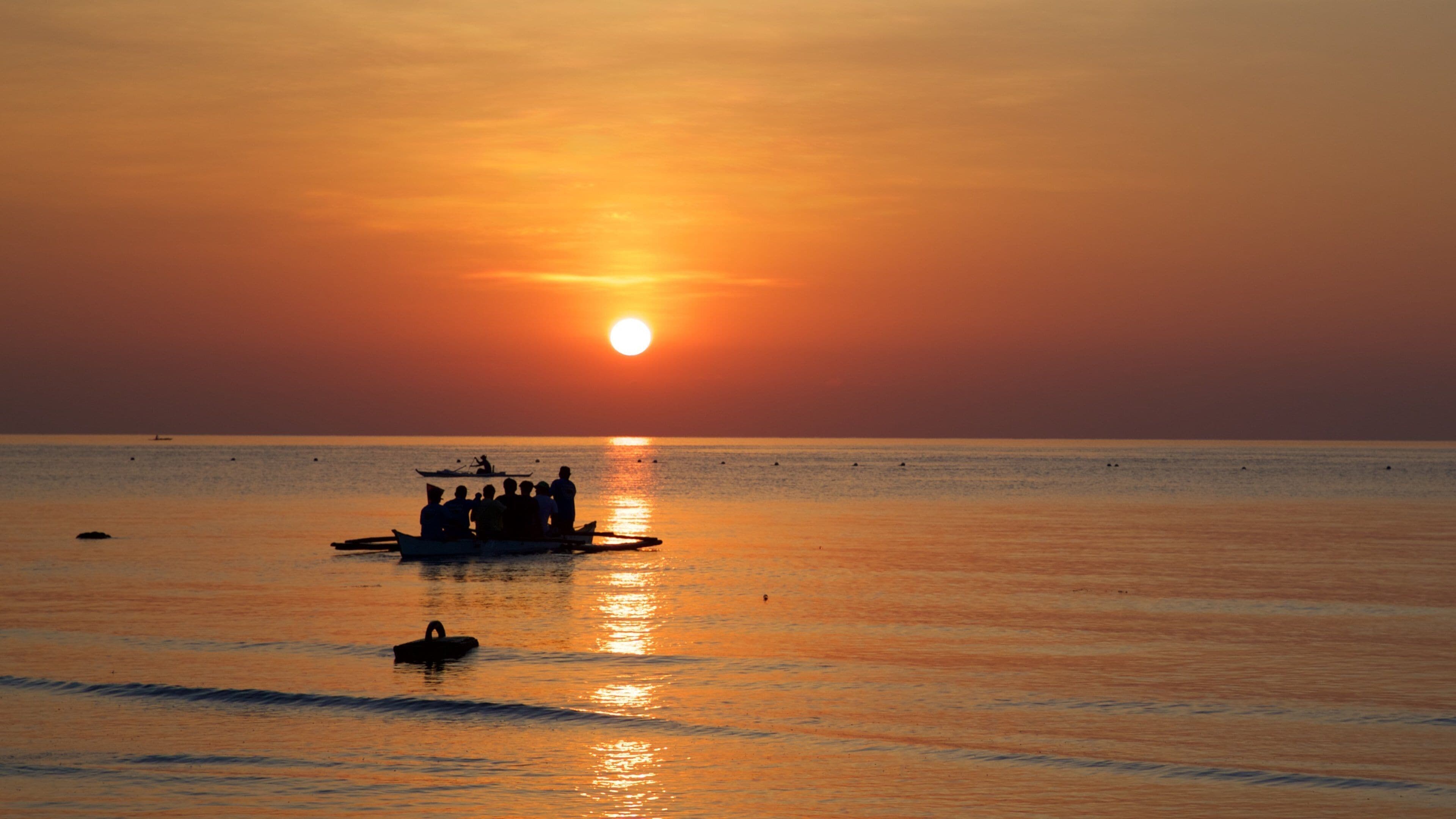 Oslob Beach which includes general coastal views, boating and a sunset