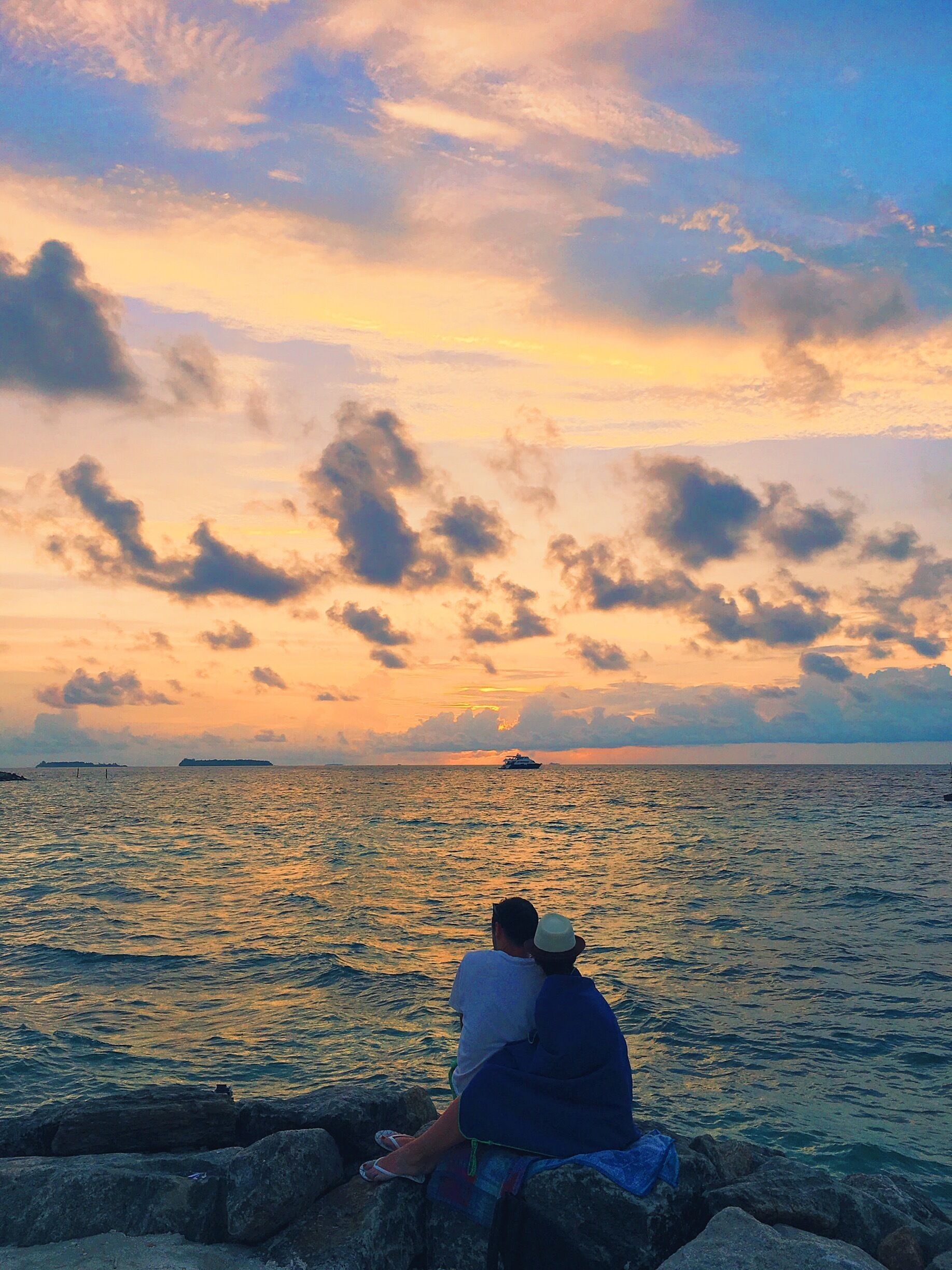 A beautiful couple watching the sun set.