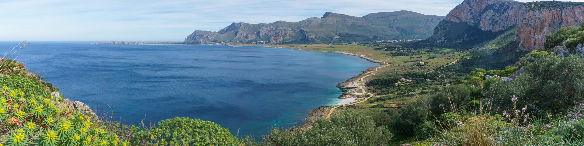 Panoramic view over mediterranean coastline with bay of sea water at Nature Park Monte Cofano with green vegetation, San Vito Lo Capo, Sicily, Italy