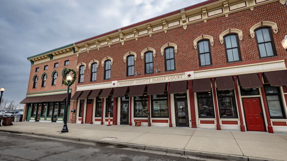A brick building with a red awning and the sign 'Madison County Family Court'.