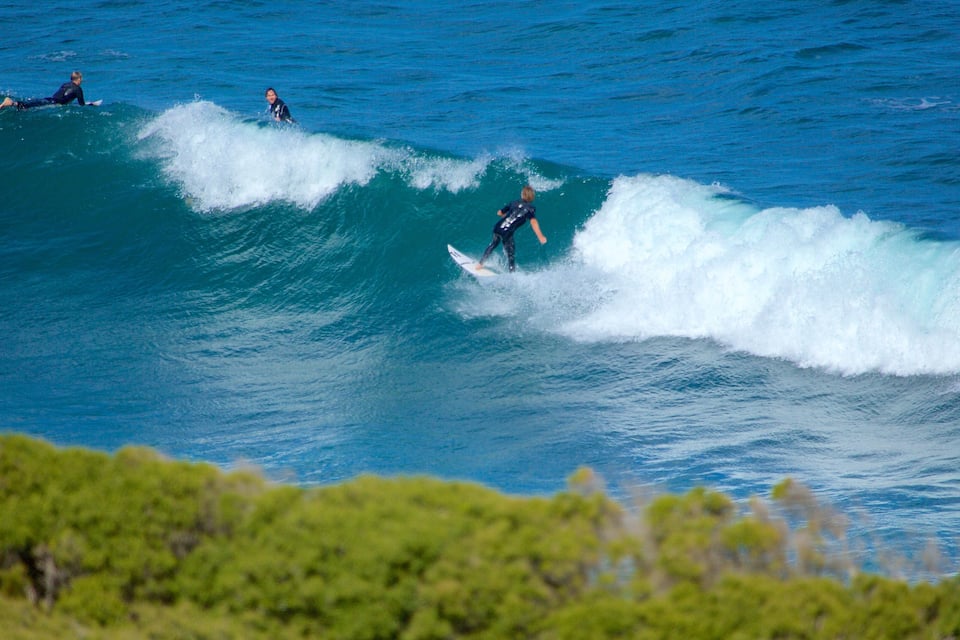 Surfers riding waves in the ocean.