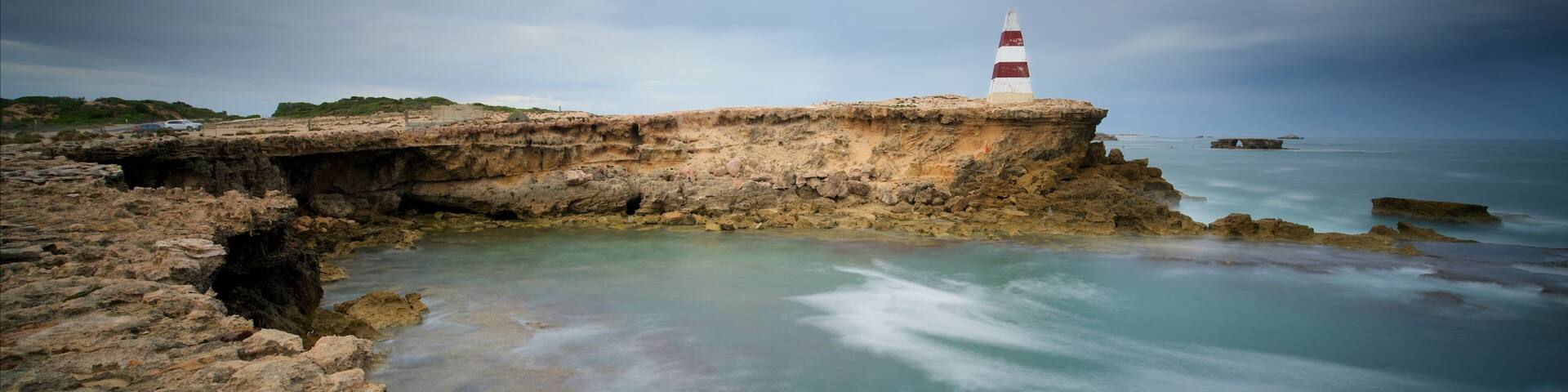Obelisk Robe which includes rocky coastline, a lighthouse and general coastal views