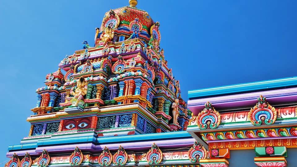A colorful temple with intricate carvings and statues.