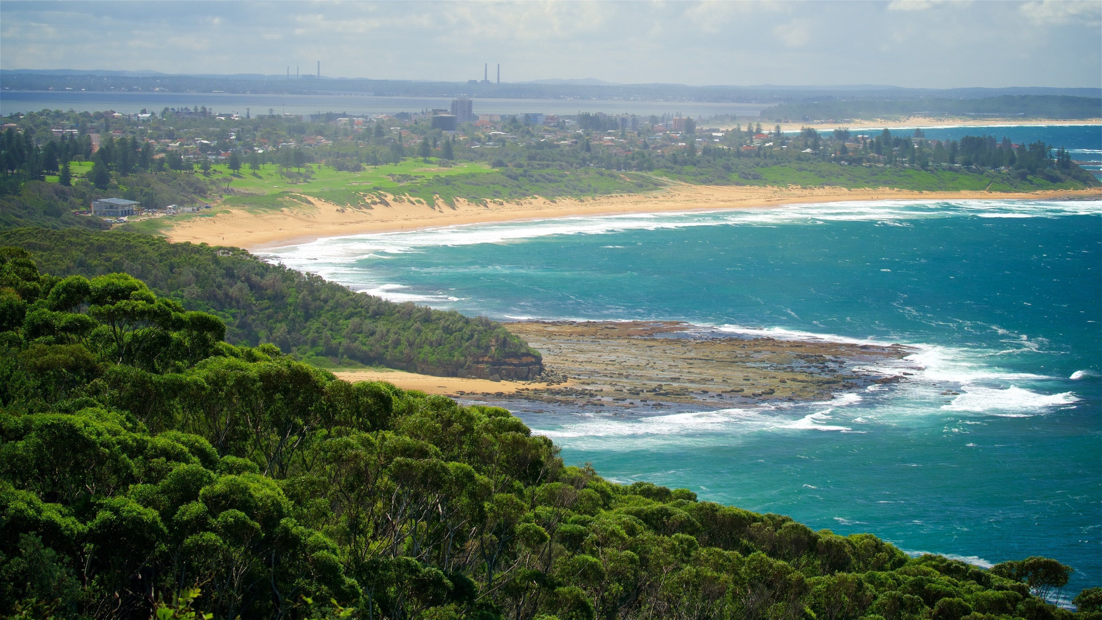 Wyrrabalong National Park which includes a bay or harbor, waves and a sandy beach