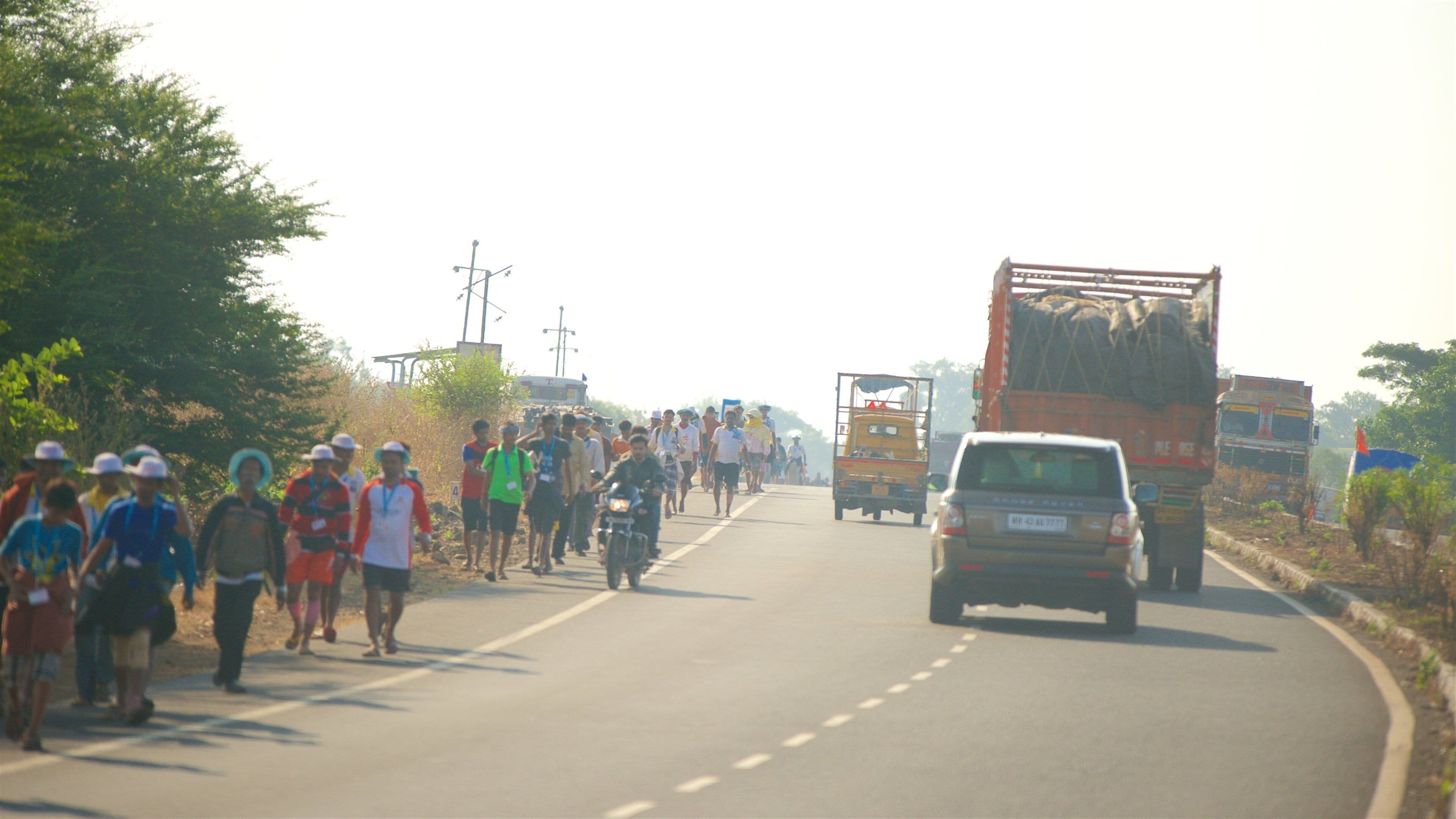 Sai Baba Temple featuring street scenes and vehicle touring as well as a large group of people