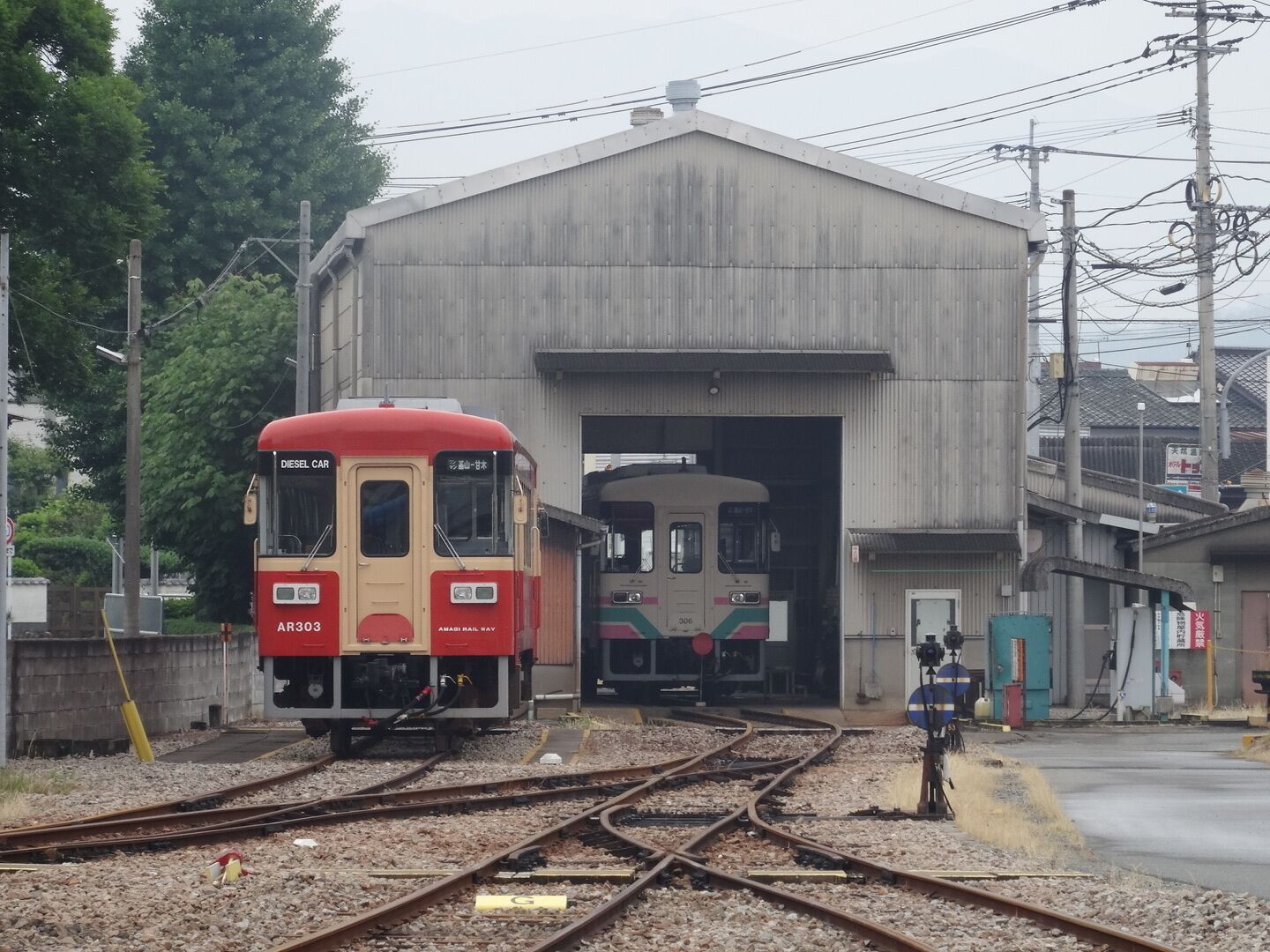 A diesel car train AR3033 entering a station.