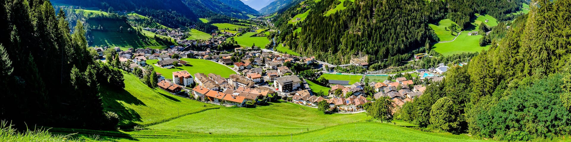 A mountainous landscape with a village nestled in a valley.
