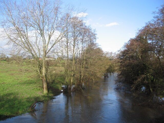 River Frome near Woolverton A view looking to the northeast along the River Frome, swollen after recent heavy rain, taken from the parapet of the bridge on the A36.