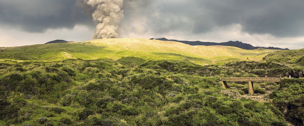 Mount Aso (阿蘇山, Asosan) is an active volcano in the center of Kyushu which most recently erupted in October 2016 but has since calmed down again. Aso's ancient caldera ranks among the world's largest, with a diameter of up to 25 kilometers and a circumference of over 100 kilometers. In the center of the caldera stand the mountain's active volcanic peaks, including Mount Nakadake, shown in this photo.
Due to increased volcanic activity at the time of our visit, a no-entry zone was currently maintained and resulted in the closure of the ropeway, road and hiking trails to the crater. Still, from a distance, we were able to witness this rare display of nature's power.