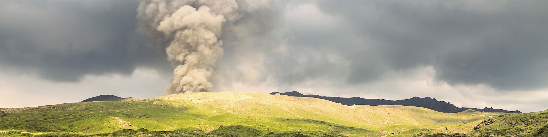 Mount Aso (阿蘇山, Asosan) is an active volcano in the center of Kyushu which most recently erupted in October 2016 but has since calmed down again. Aso's ancient caldera ranks among the world's largest, with a diameter of up to 25 kilometers and a circumference of over 100 kilometers. In the center of the caldera stand the mountain's active volcanic peaks, including Mount Nakadake, shown in this photo.
Due to increased volcanic activity at the time of our visit, a no-entry zone was currently maintained and resulted in the closure of the ropeway, road and hiking trails to the crater. Still, from a distance, we were able to witness this rare display of nature's power.