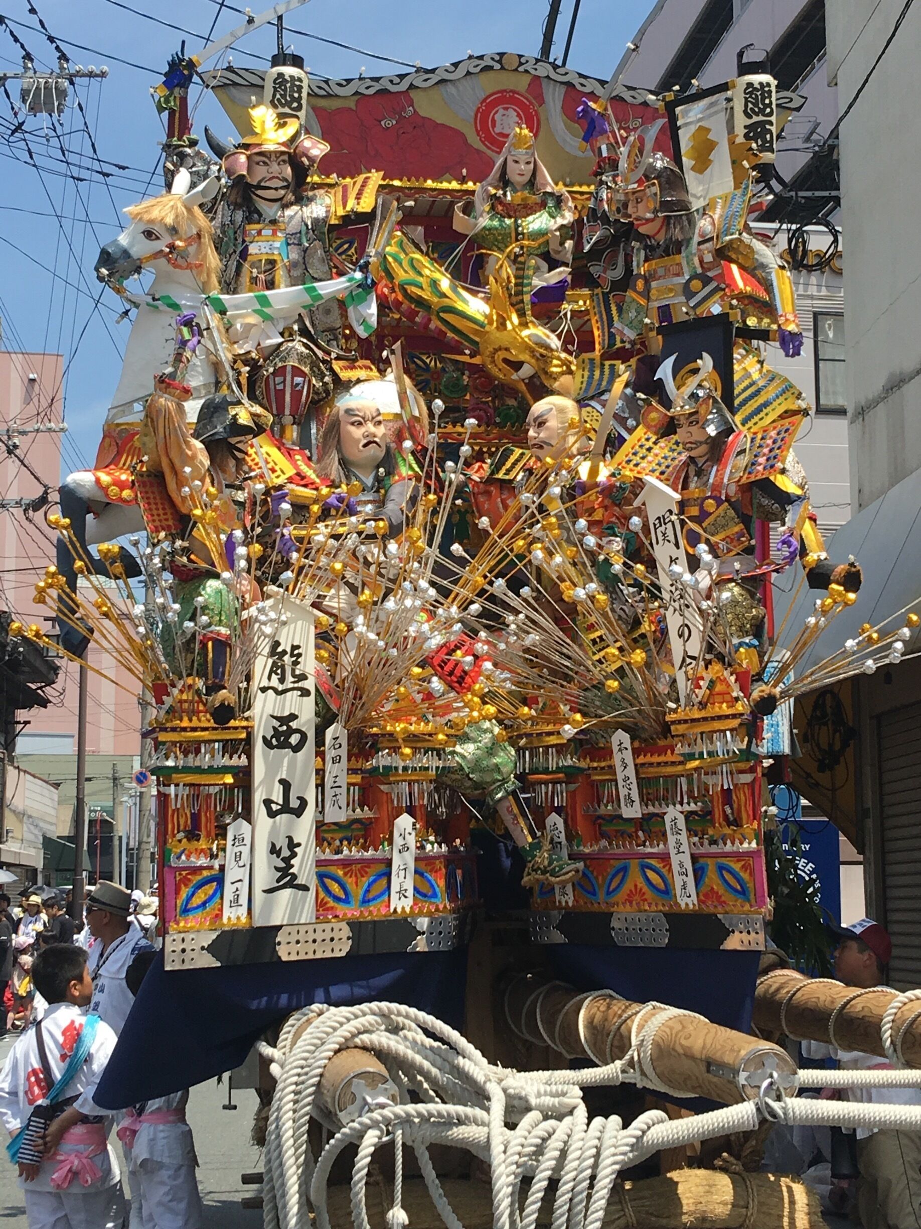 A colorful parade float with elaborate decorations and figures.