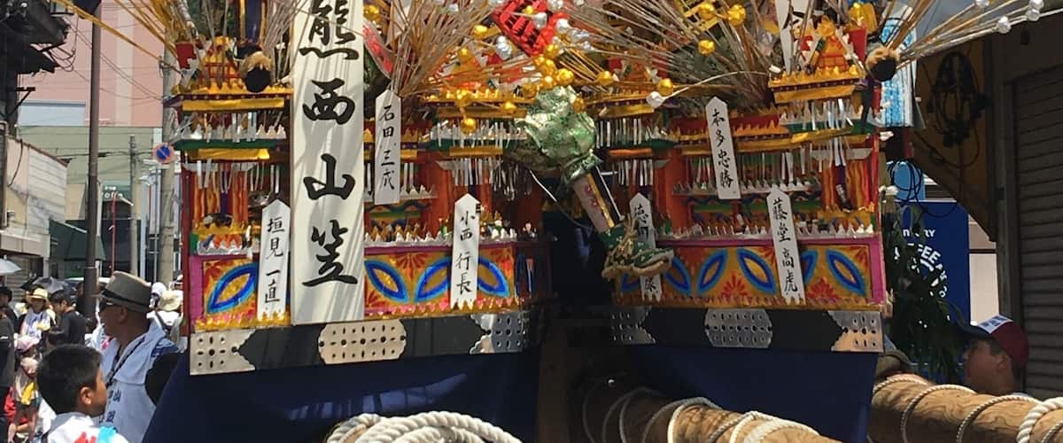 A colorful parade float with elaborate decorations and figures.