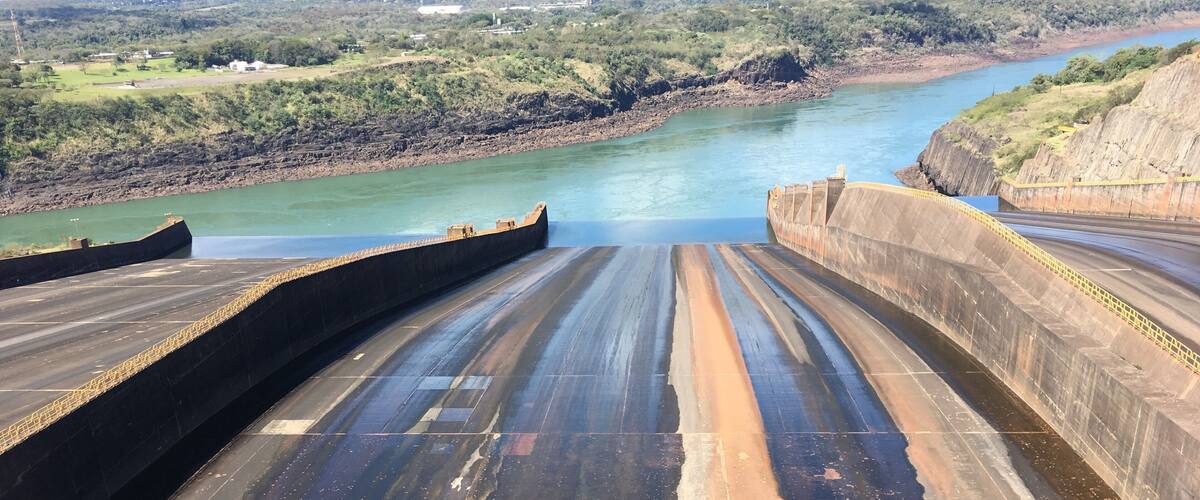 A dam with a spillway and a river.