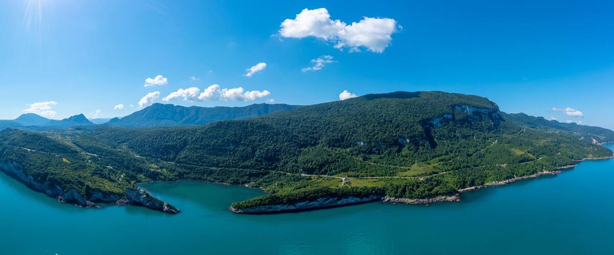 A mountainous island surrounded by clear blue waters.
