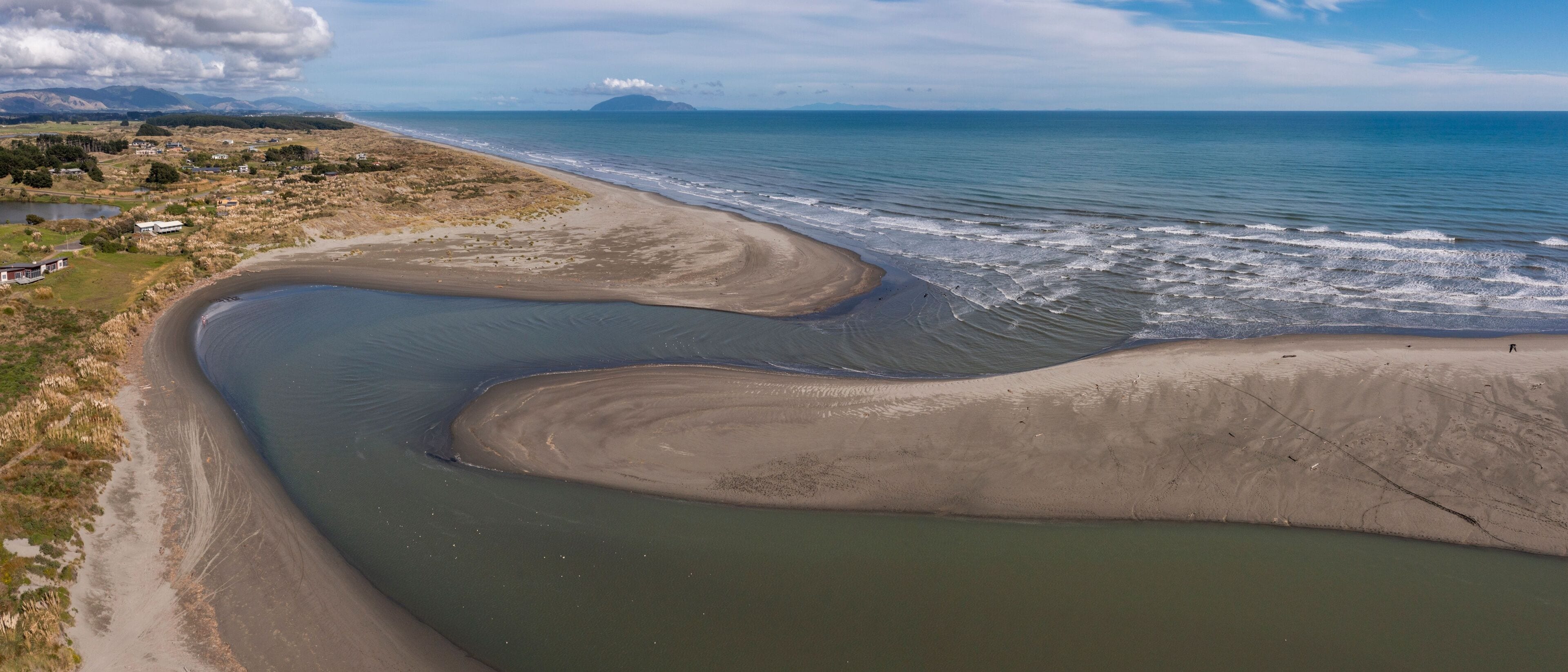 Aerial panorama of Waikawa beach and stream mouth on the Kapiti Coast of New Zealand