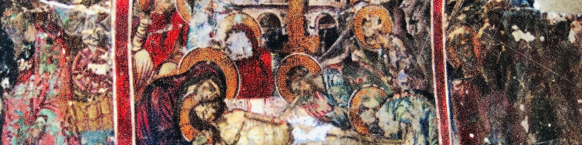 A mosaic with religious figures and a cross.