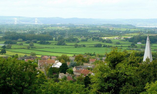 From Almondsbury church spire to the old Severn Bridge. This fine view from Over Lane north to the "bedstead" of the bridge and the hills of the Forest of Dean in the blue distance. See 685320.