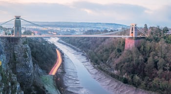 Cityscape panorama view of Bristol, England, UK and the Clifton Suspension Bridge above the Avon Gorge and River Avon at sunset or sunrise from St Vincent's Rocks.