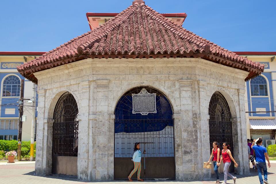 A historical building with a tiled roof and arched windows.