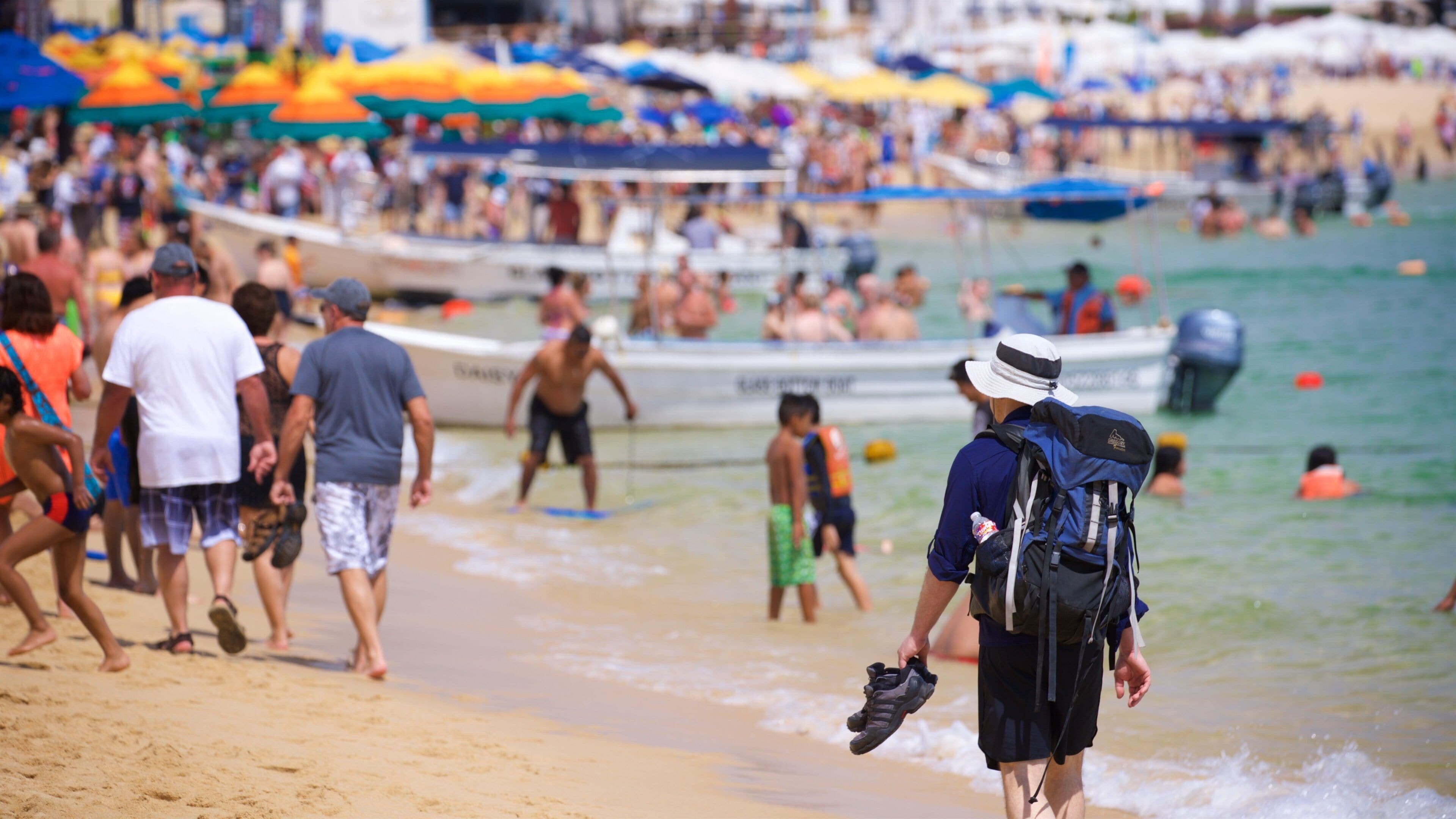 Medano Beach showing general coastal views and a beach as well as a large group of people