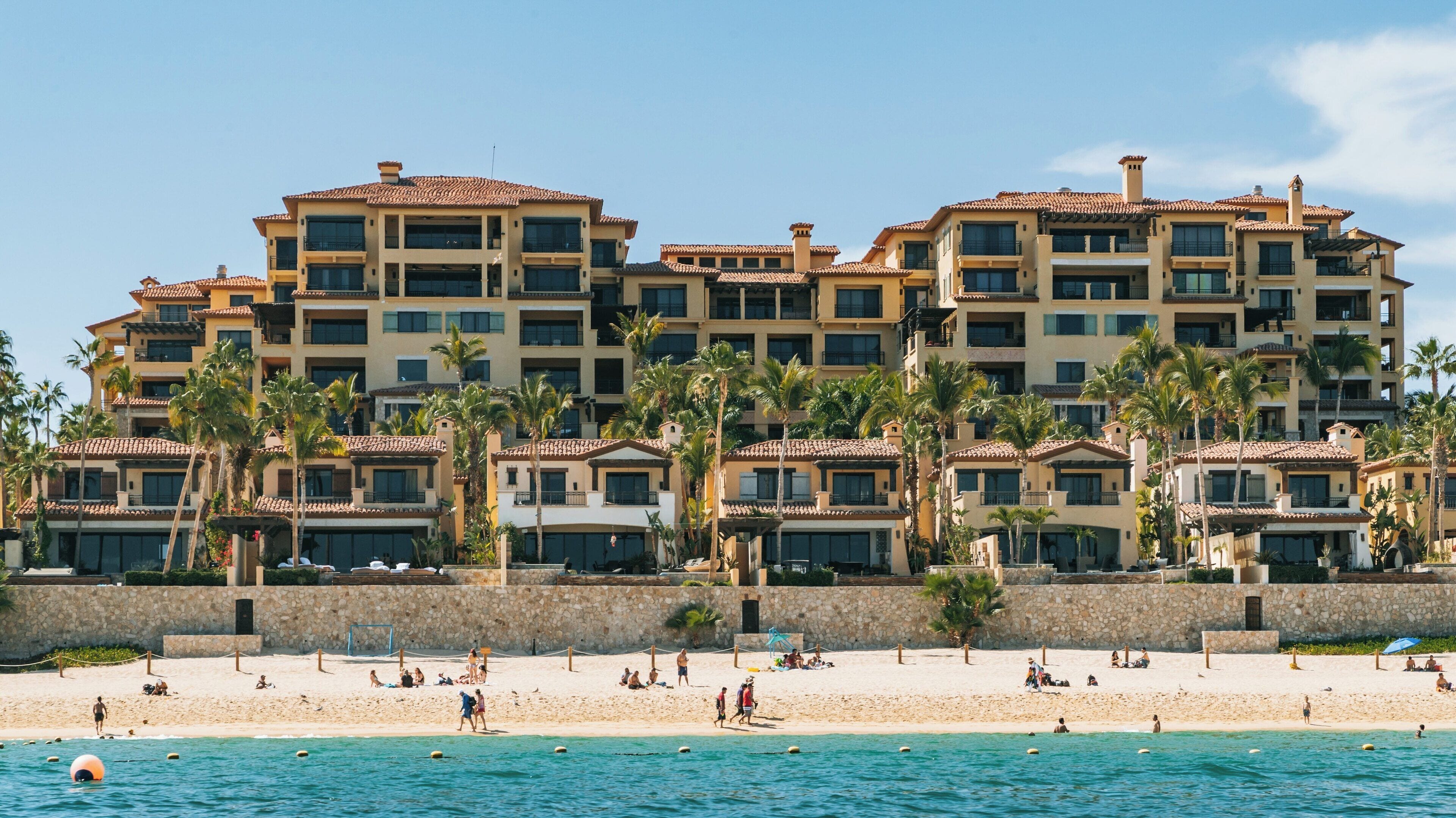 Relaxing at Medano Beach, Cabo San Lucas, where sun meets sand on a beautiful day in Baja California Sur, Mexico