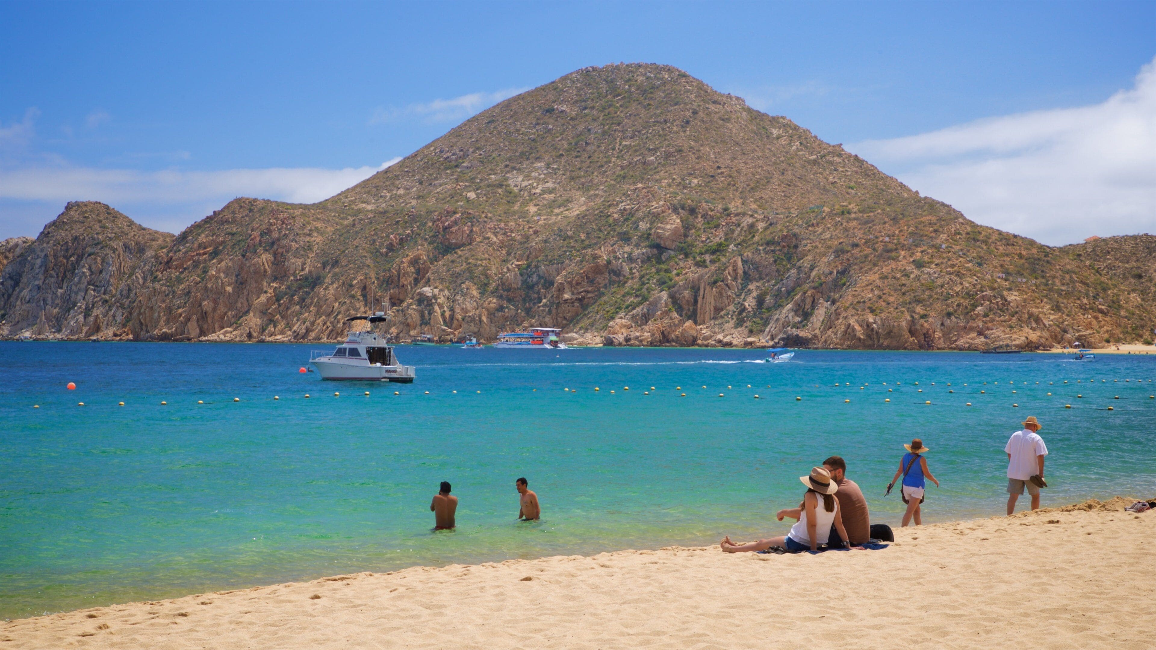 Medano Beach which includes general coastal views and a beach as well as a couple