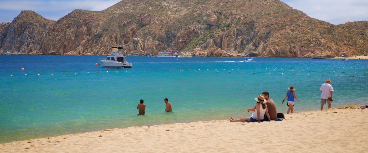 Medano Beach which includes general coastal views and a beach as well as a couple