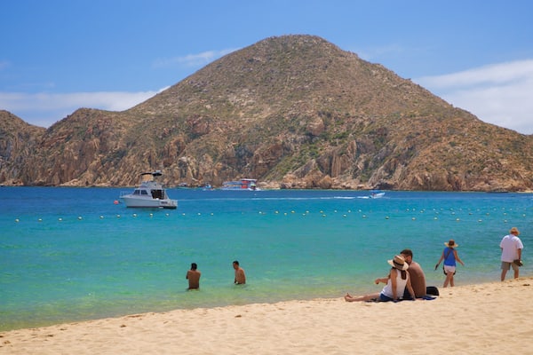 Medano Beach which includes general coastal views and a beach as well as a couple