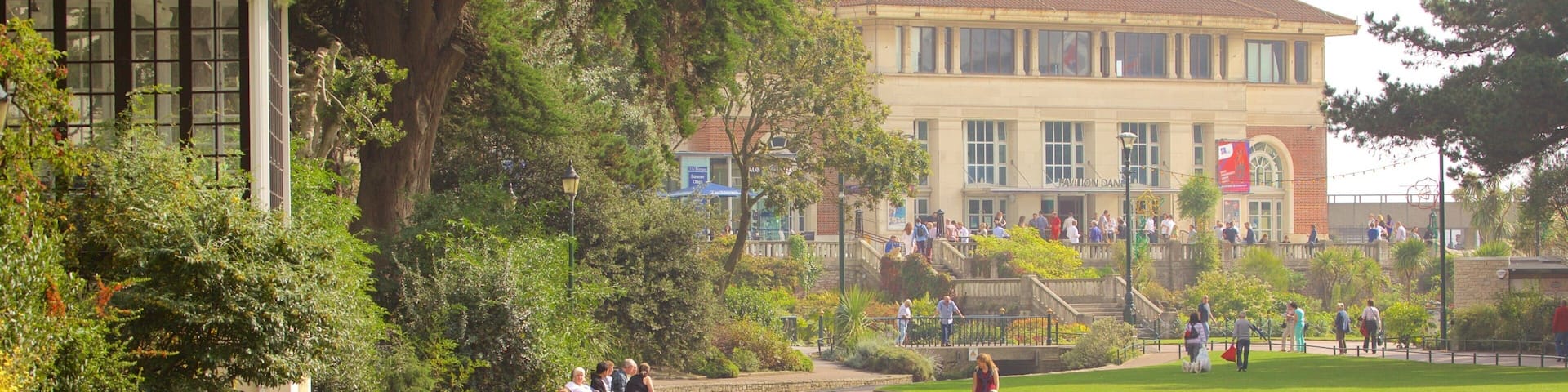 Bournemouth Lower Gardens which includes a park and a river or creek as well as a small group of people