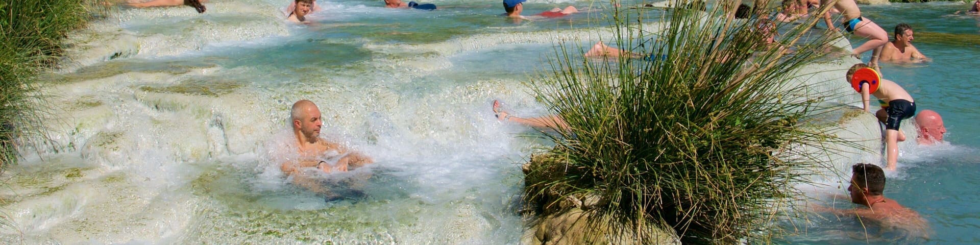 Grosseto which includes a hot spring and swimming as well as a large group of people