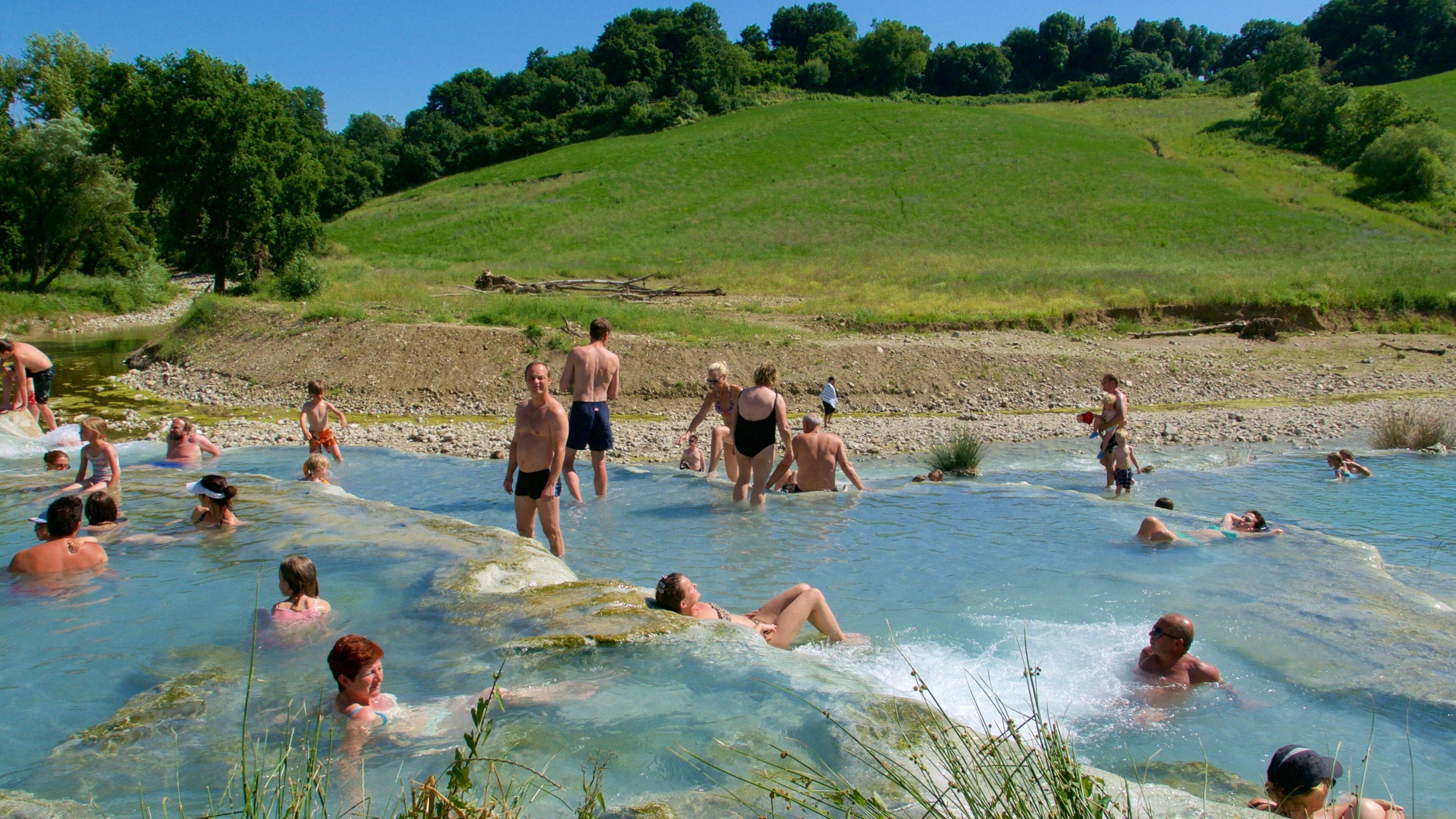 Grosseto which includes swimming and a river or creek as well as a large group of people