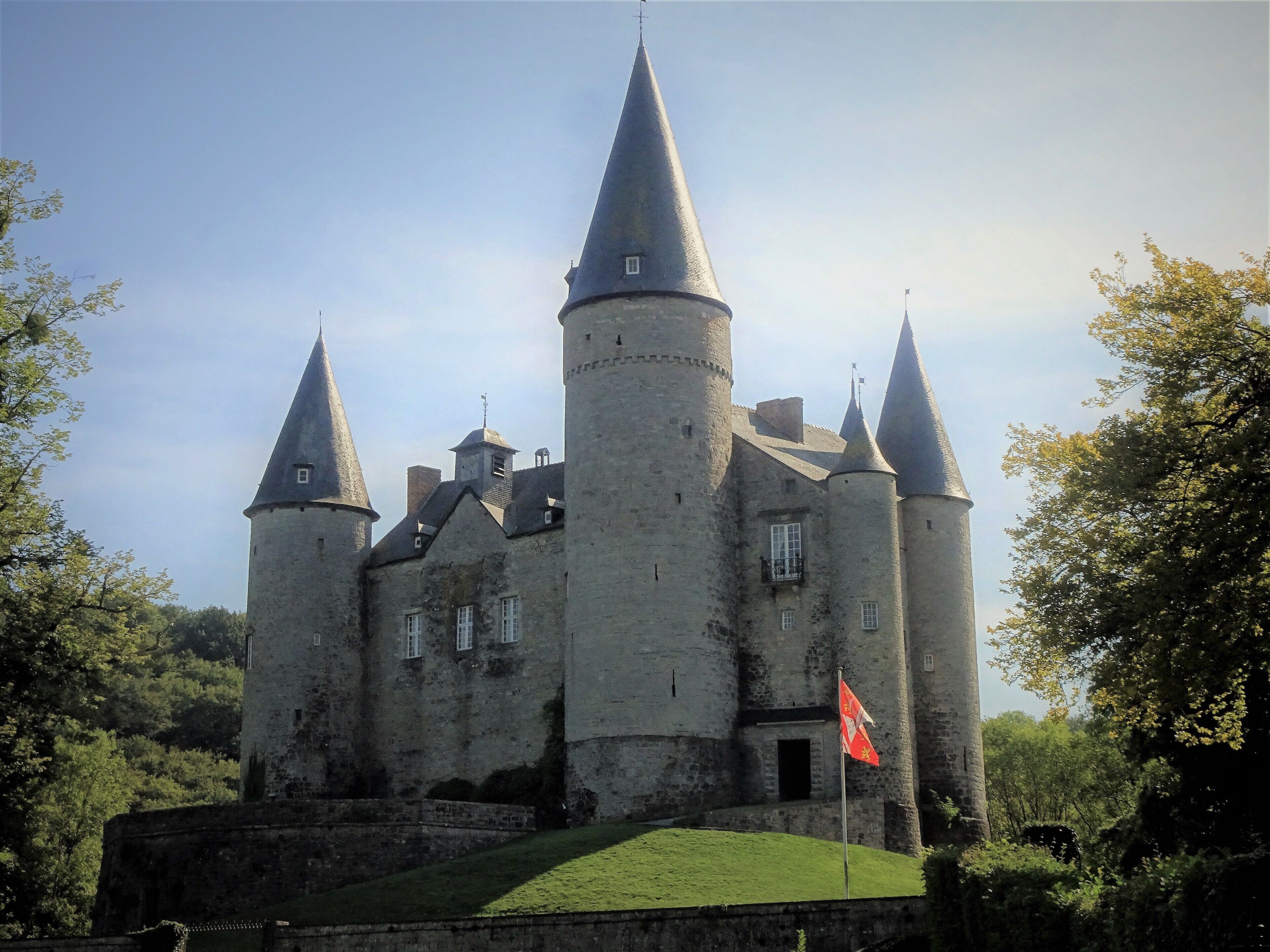A medieval castle with multiple towers and a flag.