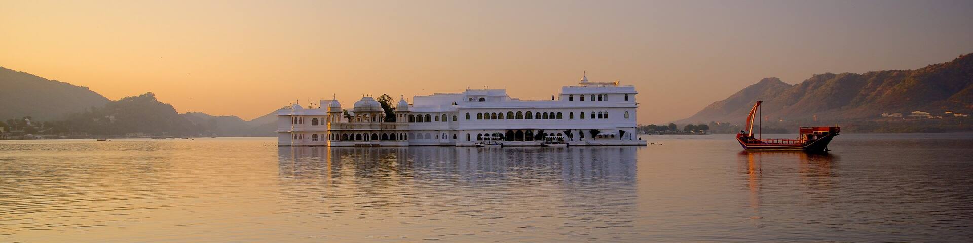 Lake Palace showing a sunset, boating and a lake or waterhole