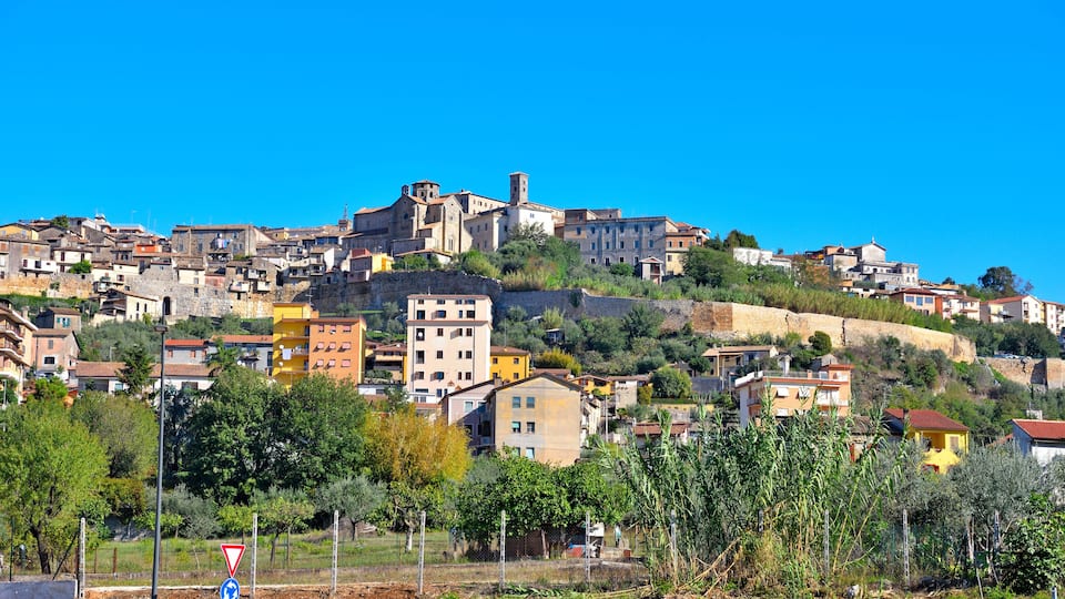 A hillside town with historic buildings and a prominent church.