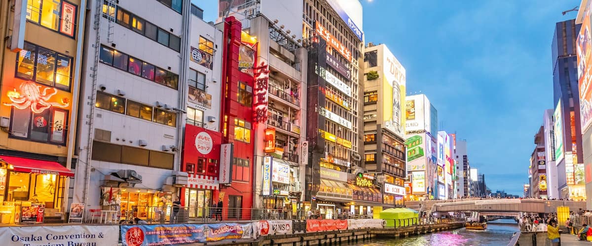 Dotonbori which includes boating, a city and a river or creek