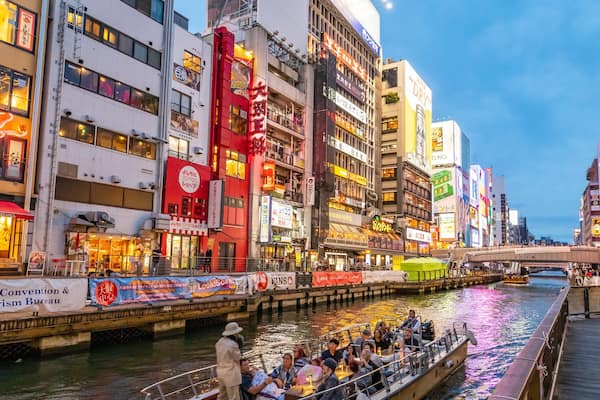 Dotonbori which includes boating, a city and a river or creek