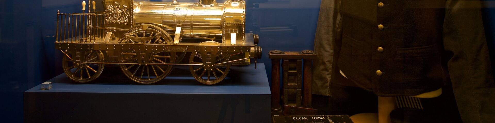 A model train and a mannequin in a display case.