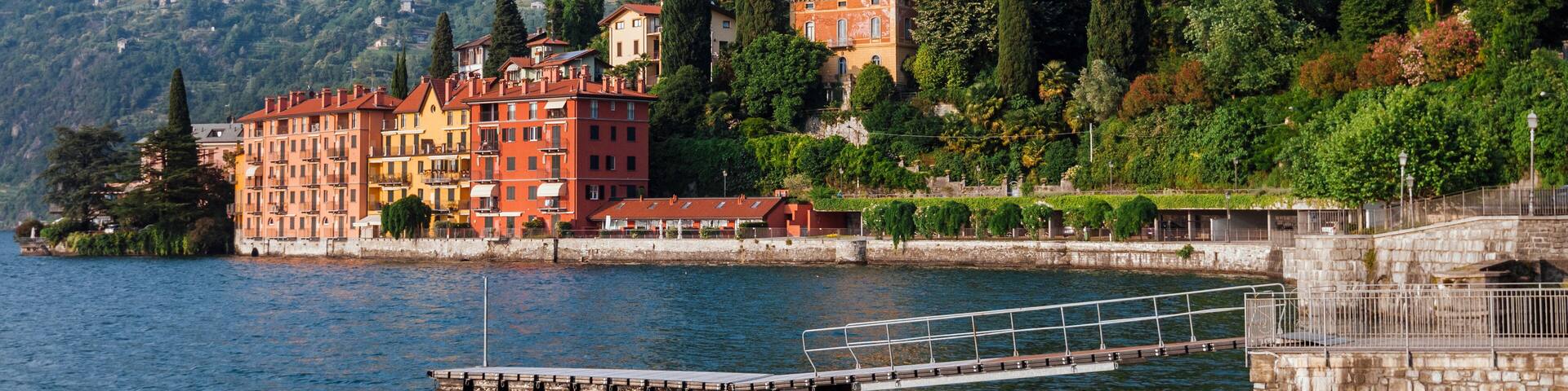 Coastline of Bellano fishing village, situated on Como Lake shore, Lombardy, Italy. Traditional italian houses, mountains and pier in small coast town Bellano.