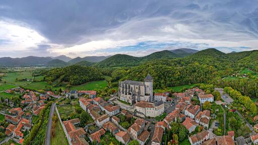 Aerial fly over above Saint-Bertrand-de-Comminges one of the Plus Beaux Villages in the French side of the Pyrenees mountains