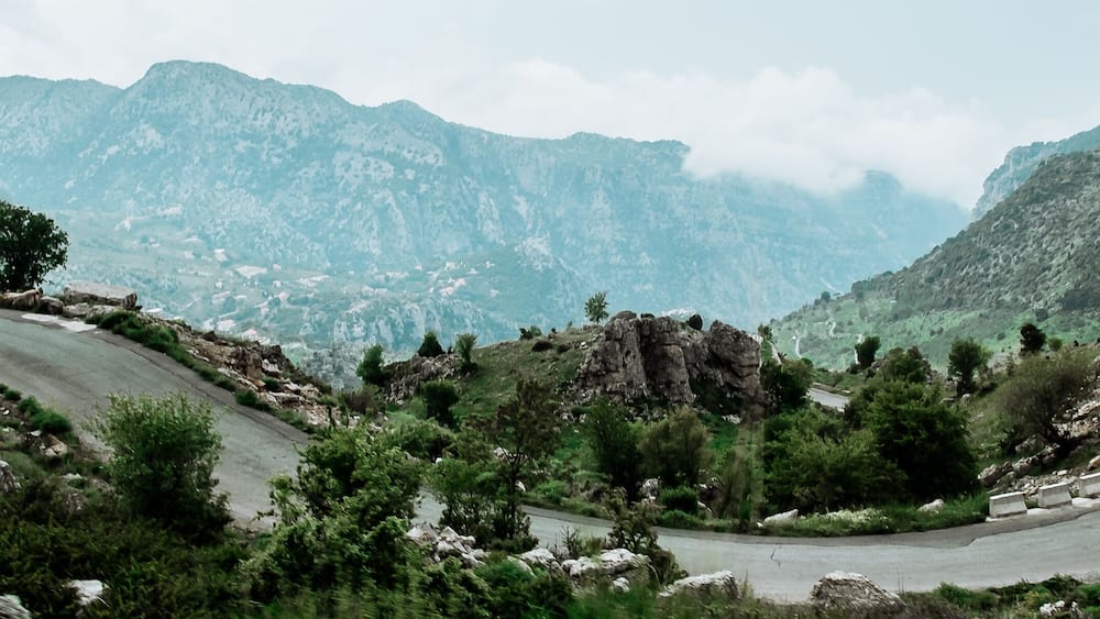 Landscape in spring in Lebanon : straight road heading to cliff and summits in Mount Lebanon,