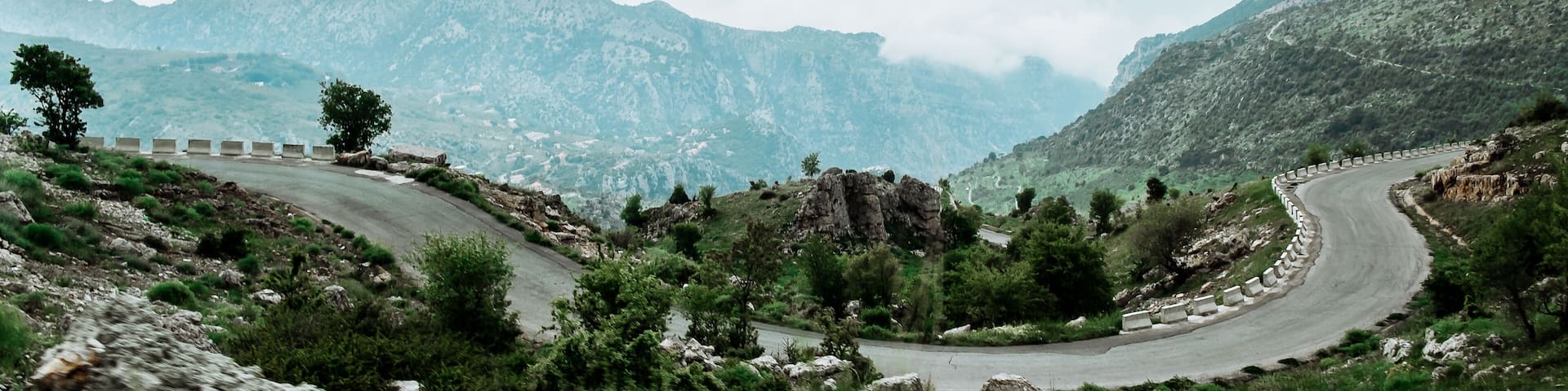 Landscape in spring in Lebanon : straight road heading to cliff and summits in Mount Lebanon,