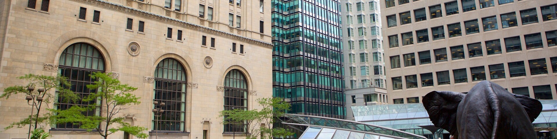 Financial District which includes a statue or sculpture, a city and modern architecture