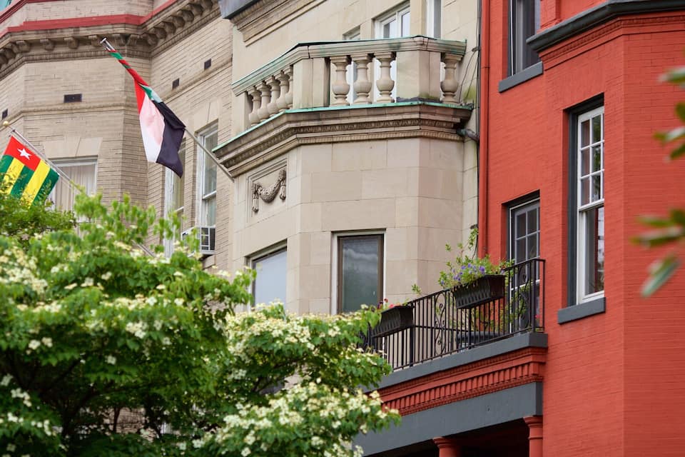 A building with a red facade and a beige stone structure.