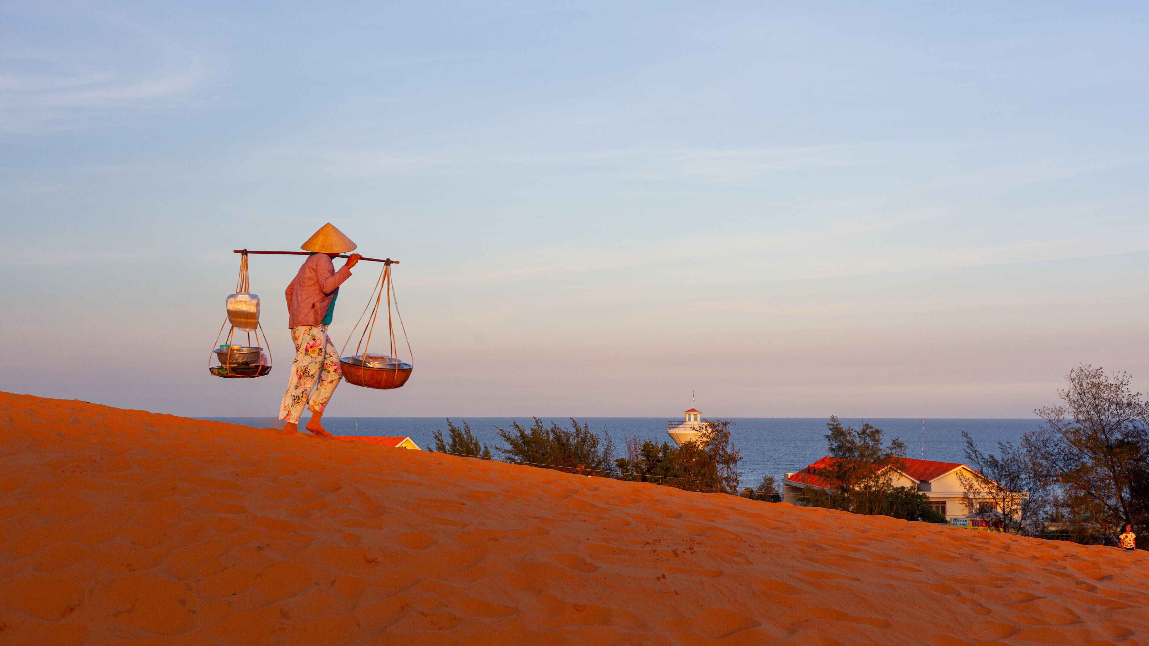Mui Ne Sand Dunes which includes a sandy beach and a sunset as well as an individual femail
