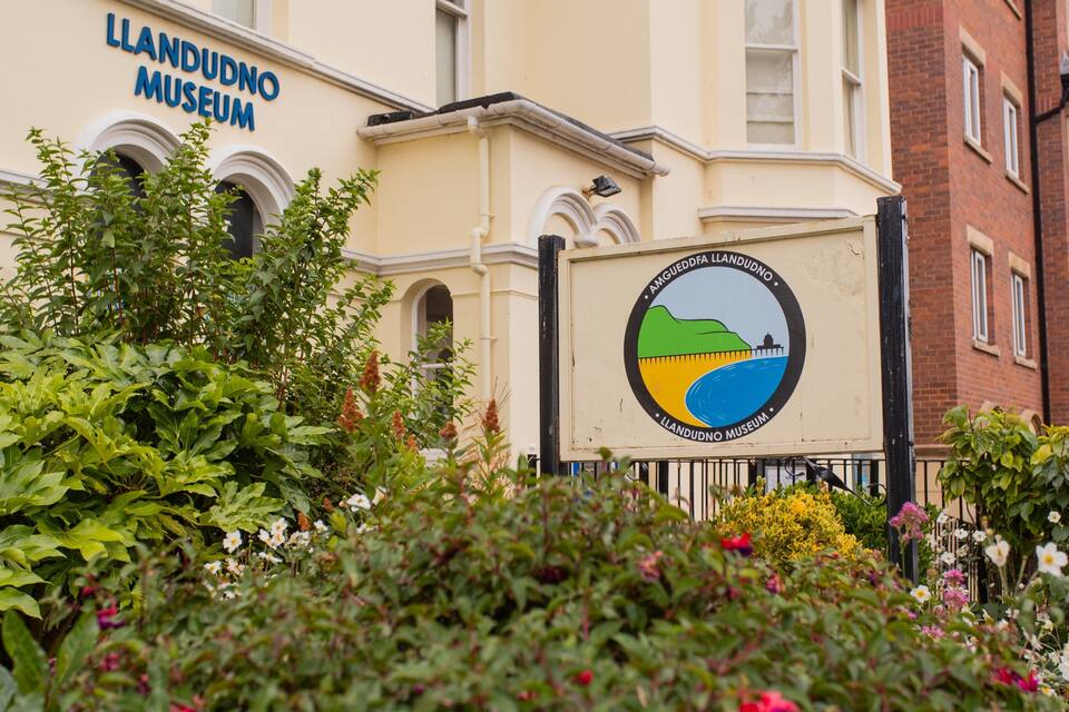 The exterior of the Llandudno Museum with its distinctive logo.