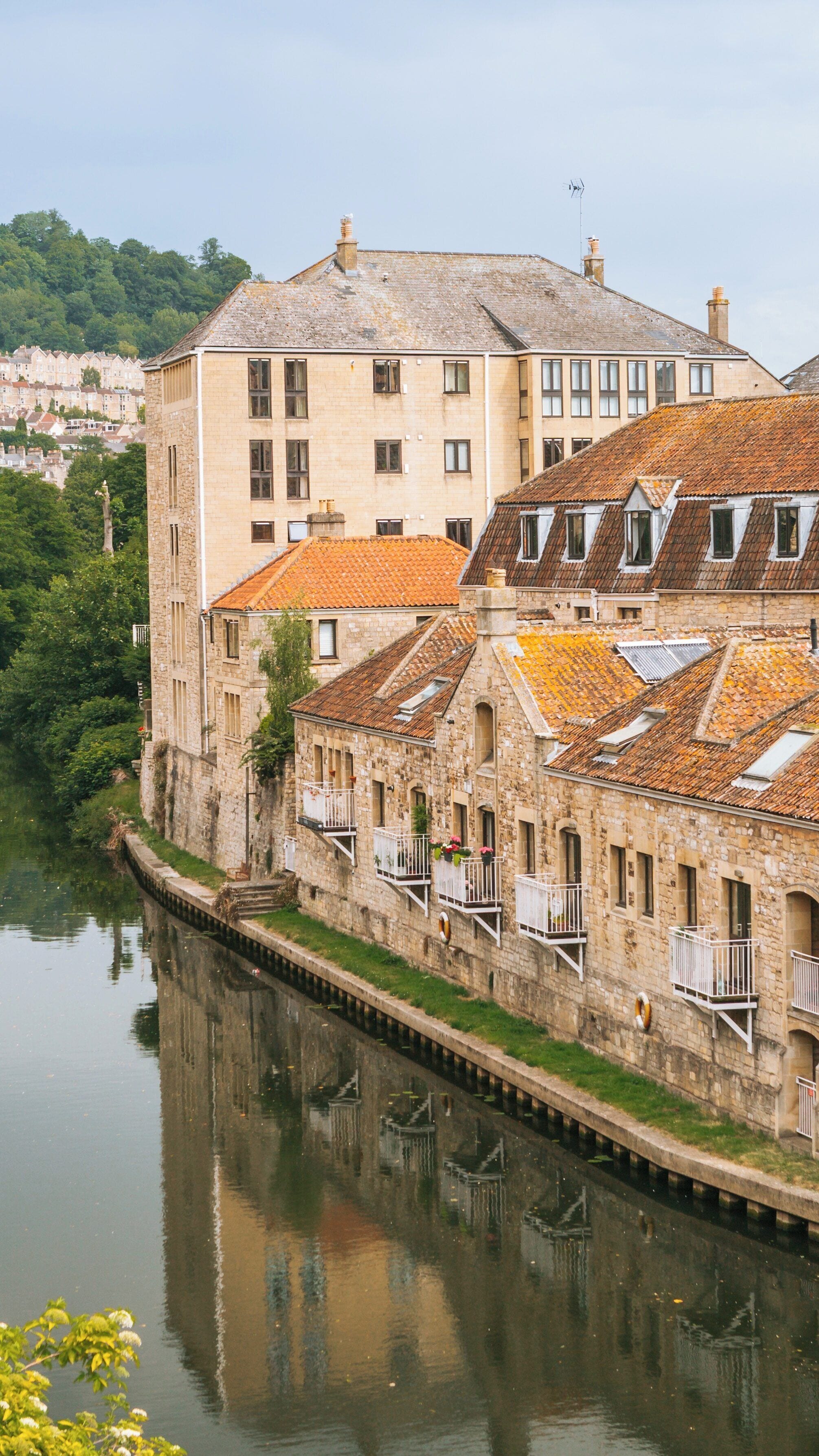 View of Pulteney Bridge and adjacent buildings along the River Avon near Bath in England showcasing stunning architecture and serene waters