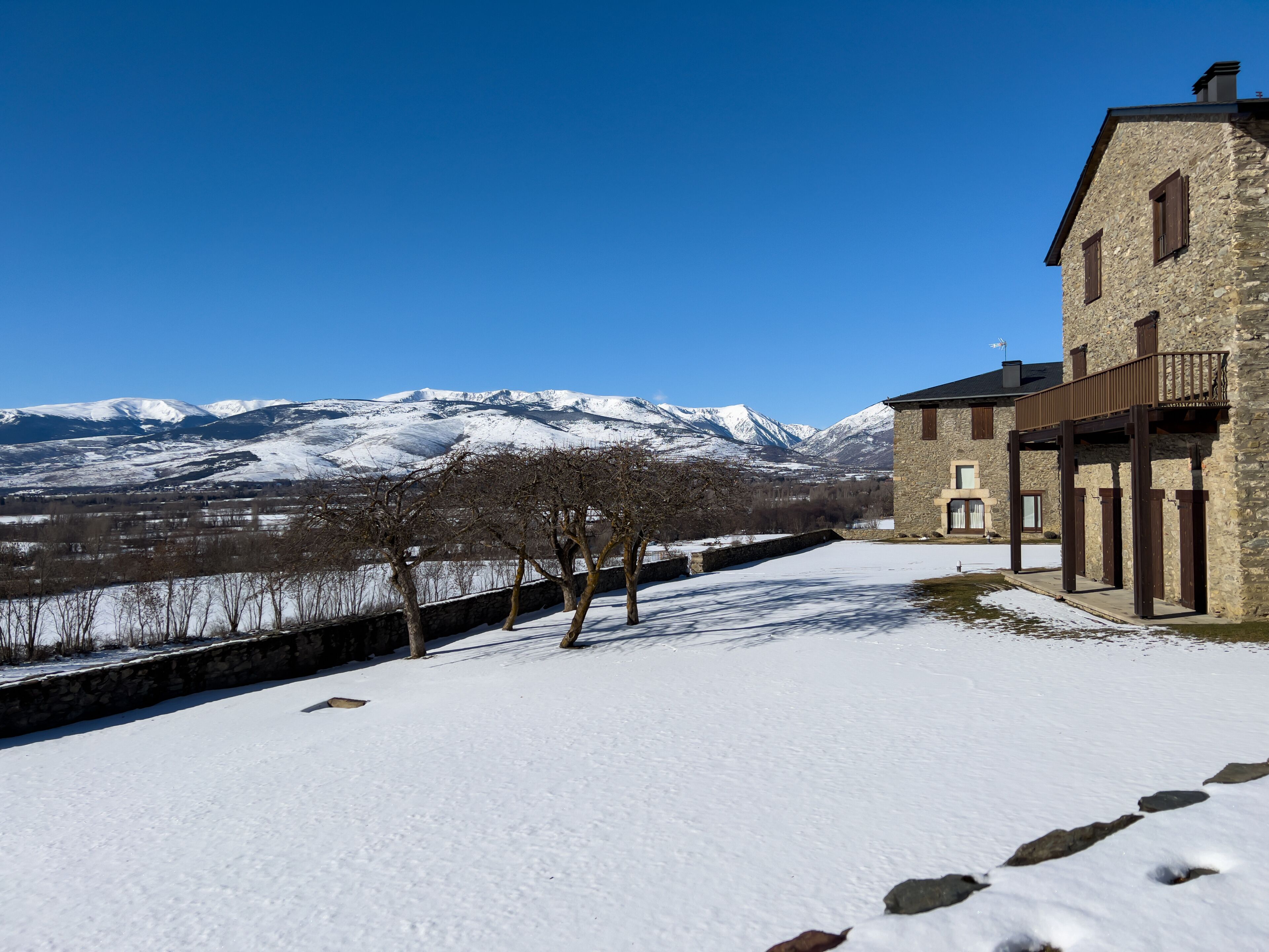 Stone buildings with snow capped mountains in Catalonia